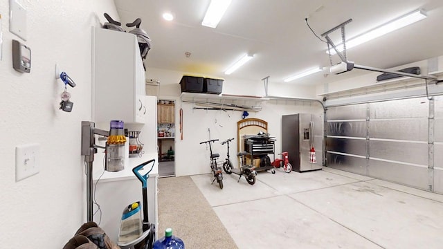 290 Cabrillo Dr, Coalinga, CA 93210 - garage featuring a garage door opener and stainless steel fridge