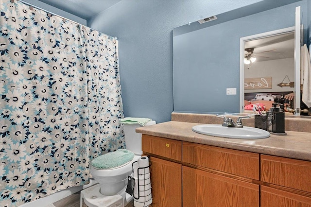 1601 El Paso, Dinuba, CA 93618 - full bath featuring vanity, toilet, ceiling fan, and a shower with shower curtain