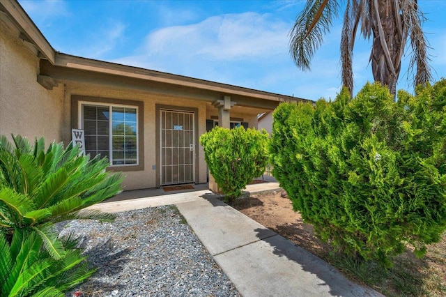 1601 El Paso, Dinuba, CA 93618 - view of exterior entry featuring stucco siding and a porch