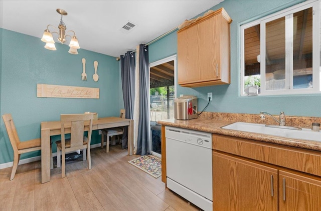 1601 El Paso, Dinuba, CA 93618 - kitchen featuring white dishwasher, light countertops, a sink, light wood-type flooring, and a chandelier