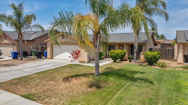 1601 El Paso, Dinuba, CA 93618 - single story home featuring a garage, concrete driveway, and stucco siding