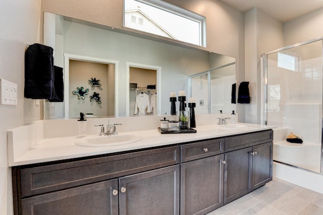 1173 Maclure Ave W, Madera, CA 93636 - bathroom with a stall shower, double vanity, a walk in closet, and tile patterned flooring