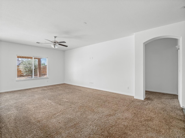 1585 Dallas St, Dinuba, CA 93618 - carpeted empty room featuring arched walkways, a ceiling fan, and baseboards