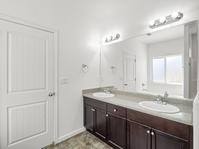 1585 Dallas St, Dinuba, CA 93618 - full bathroom with baseboards and double vanity