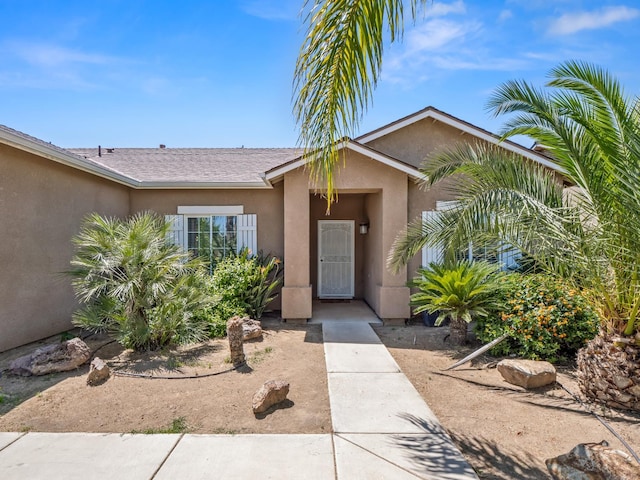 1585 Dallas St, Dinuba, CA 93618 - doorway to property featuring stucco siding