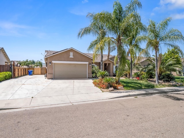 1585 Dallas St, Dinuba, CA 93618 - view of front of property featuring a garage, stucco siding, fence, and concrete driveway