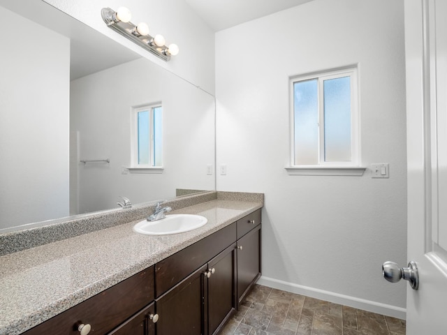 1585 Dallas St, Dinuba, CA 93618 - bathroom with baseboards, healthy amount of natural light, and vanity