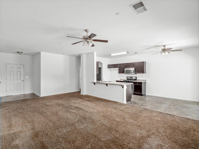 1585 Dallas St, Dinuba, CA 93618 - unfurnished living room with a ceiling fan, baseboards, light carpet, and arched walkways