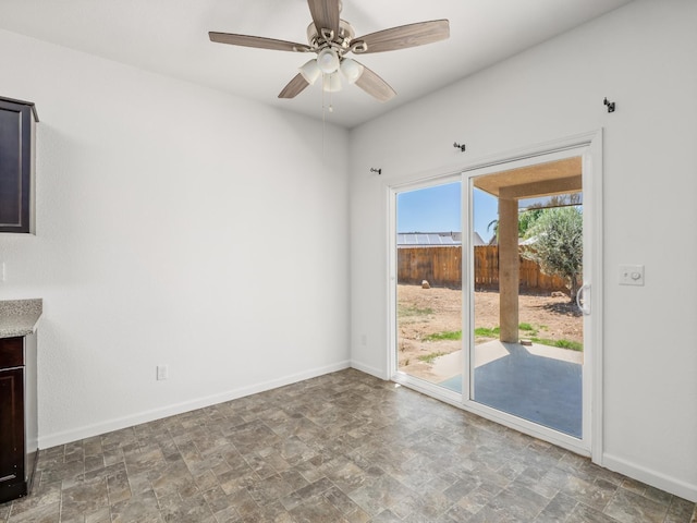 1585 Dallas St, Dinuba, CA 93618 - empty room with stone finish floors, a ceiling fan, and baseboards