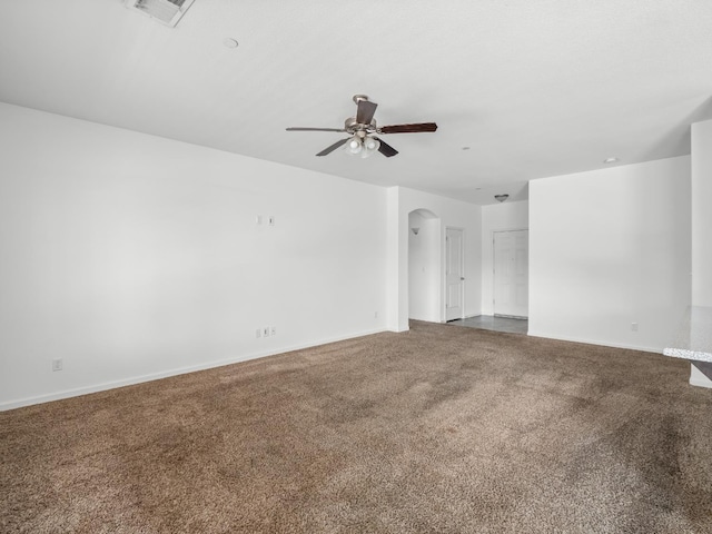 1585 Dallas St, Dinuba, CA 93618 - spare room with arched walkways, a ceiling fan, carpet, and baseboards