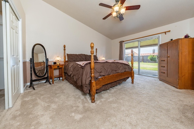 bedroom with vaulted ceiling, access to exterior, light colored carpet, and a ceiling fan