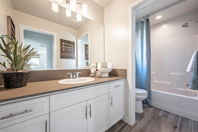 1161 Maclure Ave W, Madera, CA 93636 - full bathroom with toilet, vanity, wood finished floors, and shower / bath combo with shower curtain