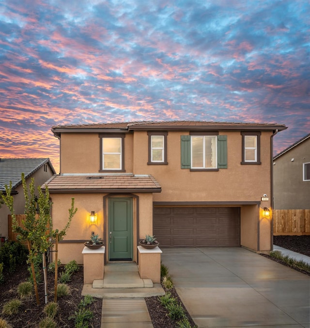 1161 Maclure Ave W, Madera, CA 93636 - multi unit property featuring a garage, stucco siding, driveway, fence, and a tiled roof