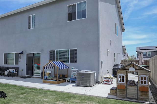 324 Sunset Dr S, Madera, CA 93636 - back of house with central air condition unit, fence, a patio area, and stucco siding