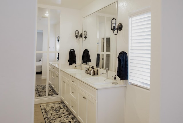 324 Sunset Dr S, Madera, CA 93636 - full bathroom with double vanity, ensuite bath, and wood finished floors
