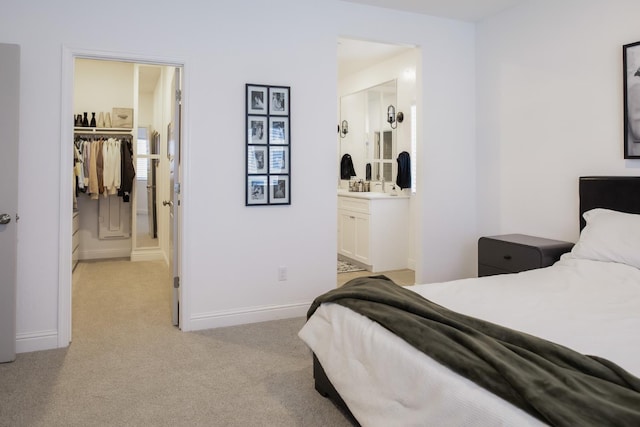 324 Sunset Dr S, Madera, CA 93636 - bedroom with light carpet, baseboards, and connected bathroom