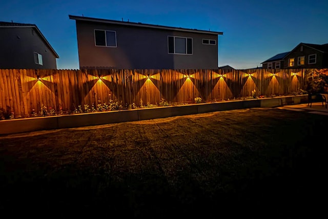 324 Sunset Dr S, Madera, CA 93636 - yard at dusk featuring a fenced backyard