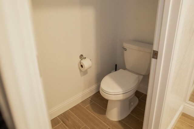 324 Sunset Dr S, Madera, CA 93636 - bathroom featuring toilet, baseboards, and wood finished floors
