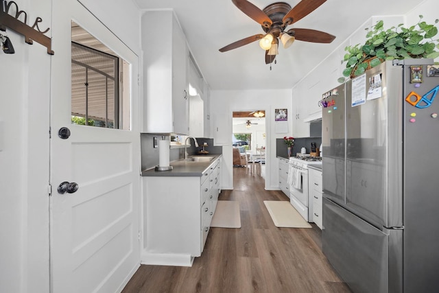 261 Belmont Rd, Exeter, CA 93221 - kitchen featuring freestanding refrigerator, white gas range, a ceiling fan, a sink, and dark wood-type flooring