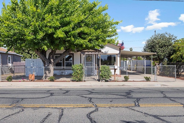 261 Belmont Rd, Exeter, CA 93221 - view of front of house with a fenced front yard, an attached carport, a gate, and concrete driveway
