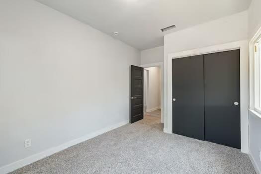 705 Poplar, Fresno, CA 93728 - unfurnished bedroom with carpet floors, a closet, and baseboards