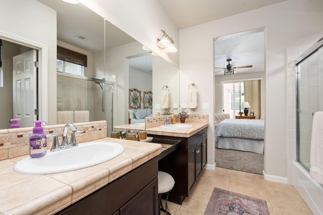3942 Harlan Ranch Blvd, Clovis, CA 93619 - ensuite bathroom featuring ceiling fan, tiled shower, plenty of natural light, and two vanities