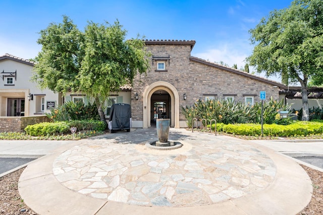 3942 Harlan Ranch Blvd, Clovis, CA 93619 - mediterranean / spanish-style house featuring a tiled roof and stone siding