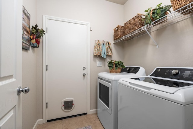 3942 Harlan Ranch Blvd, Clovis, CA 93619 - laundry area with washing machine and clothes dryer, baseboards, and light tile patterned floors