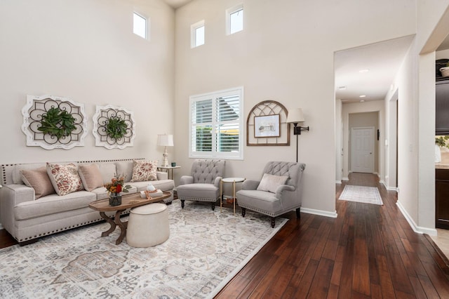 3942 Harlan Ranch Blvd, Clovis, CA 93619 - living area with dark wood-style floors, baseboards, and a towering ceiling