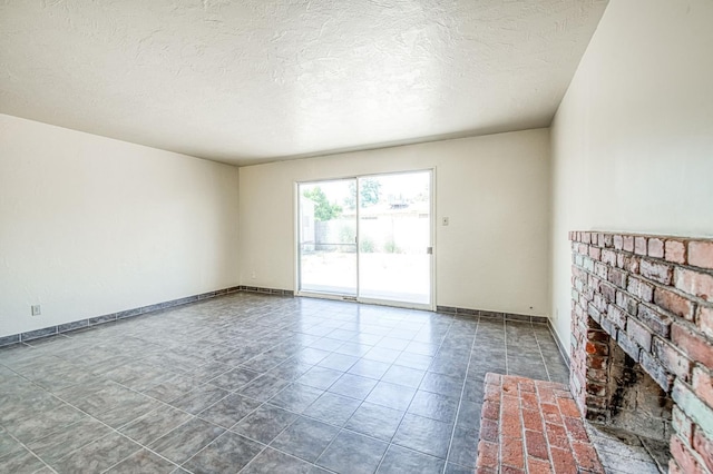 3757 E Farrin Ave, Fresno, CA 93726 - spare room with a brick fireplace, a textured ceiling, and tile patterned floors