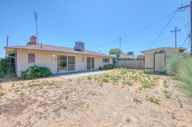 3757 E Farrin Ave, Fresno, CA 93726 - rear view of property with stucco siding, cooling unit, a patio area, and a chimney