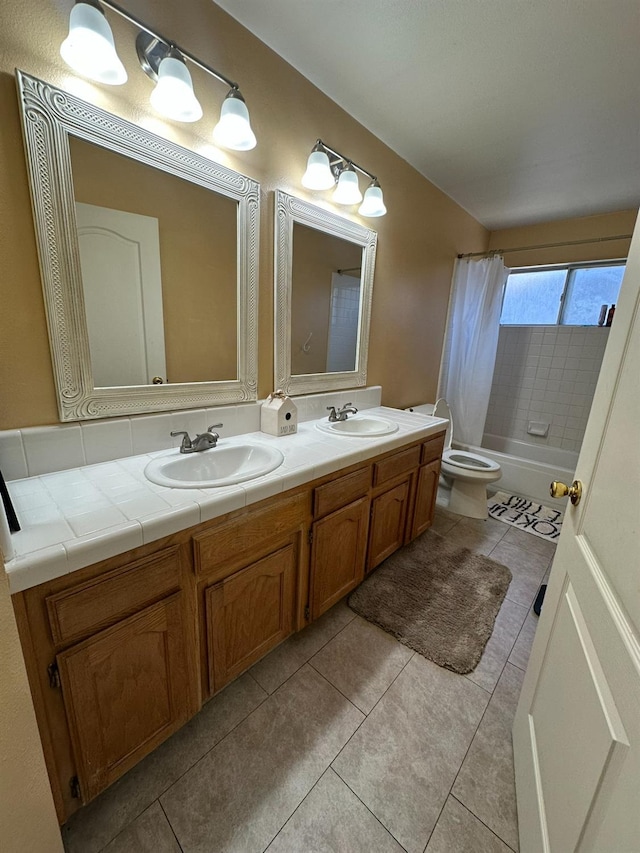 5838 W Fallon Ave, Fresno, CA 93722 - bathroom with tile patterned floors, double vanity, toilet, and shower / bath combo