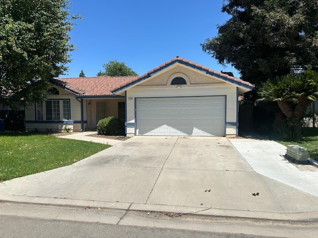 5838 W Fallon Ave, Fresno, CA 93722 - single story home with a tiled roof, a front yard, driveway, and an attached garage