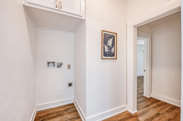 1010 N Ferger Ave, Fresno, CA 93728 - washroom featuring electric dryer hookup, wood finished floors, washer hookup, cabinet space, and baseboards
