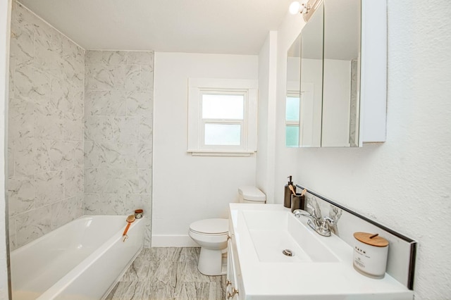 1010 N Ferger Ave, Fresno, CA 93728 - full bathroom featuring toilet, baseboards, vanity, and washtub / shower combination