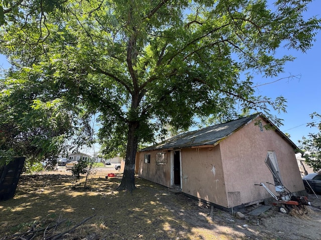 13592 E Cypress Ave, Parlier, CA 93648 - view of home's exterior featuring stucco siding and an outbuilding