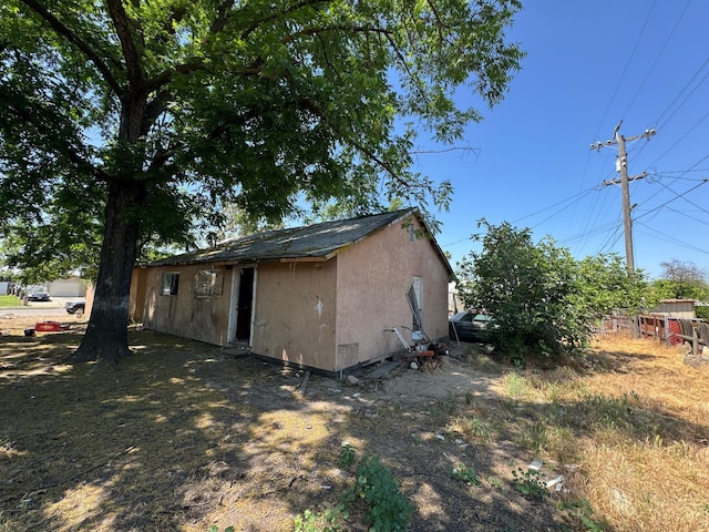13592 E Cypress Ave, Parlier, CA 93648 - view of property exterior with stucco siding and an outbuilding