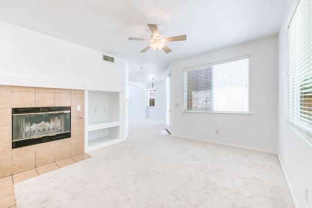 83 W Bohemia Ln, Clovis, CA 93619 - unfurnished living room with a fireplace, a ceiling fan, baseboards, and light colored carpet