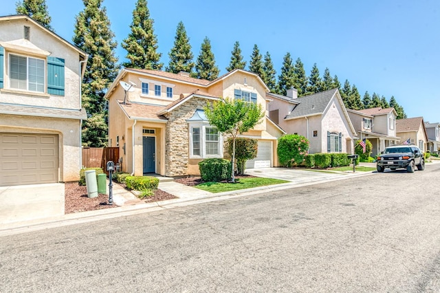83 W Bohemia Ln, Clovis, CA 93619 - traditional-style home with concrete driveway, a garage, stucco siding, stone siding, and a residential view