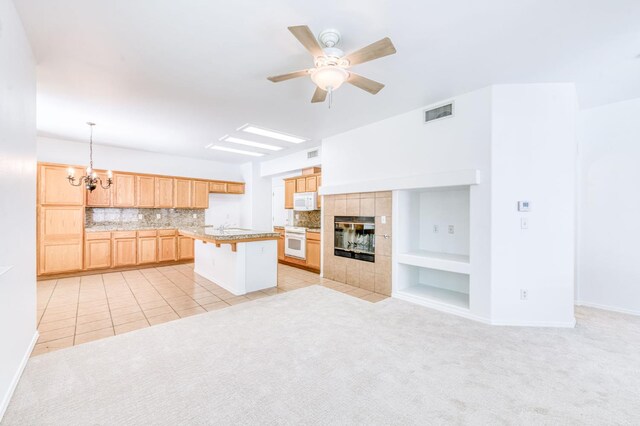 83 W Bohemia Ln, Clovis, CA 93619 - kitchen with white appliances, a chandelier, a ceiling fan, light brown cabinetry, and open floor plan