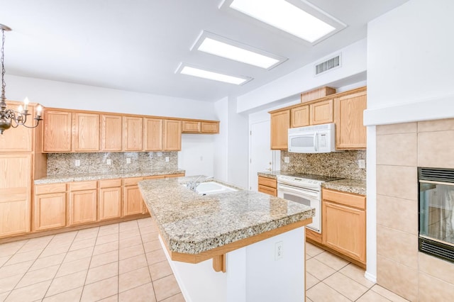 83 W Bohemia Ln, Clovis, CA 93619 - kitchen with white appliances, a sink, light tile patterned floors, decorative backsplash, and a chandelier