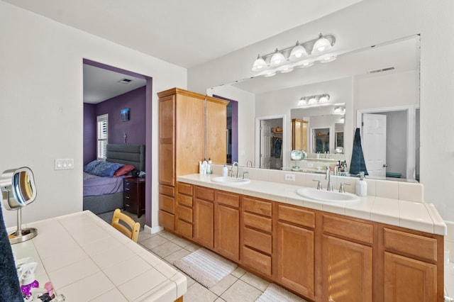 993 Pinewood Ave, Sanger, CA 93657 - bathroom with tile patterned floors and double vanity