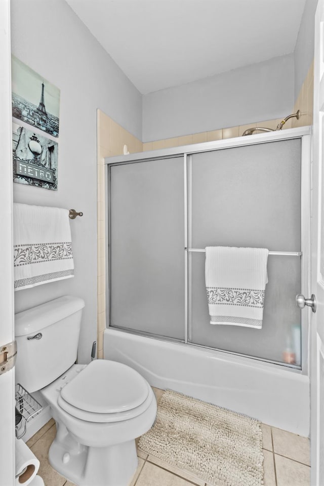 993 Pinewood Ave, Sanger, CA 93657 - bathroom featuring shower / bath combination with glass door, tile patterned floors, and toilet