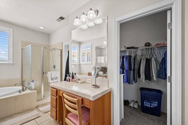 993 Pinewood Ave, Sanger, CA 93657 - bathroom featuring a stall shower, healthy amount of natural light, a walk in closet, and a bath