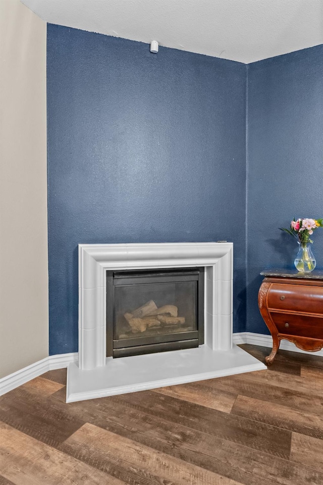 993 Pinewood Ave, Sanger, CA 93657 - detailed view of wood finished floors, a glass covered fireplace, and baseboards