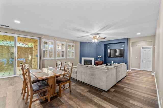 993 Pinewood Ave, Sanger, CA 93657 - living area with ceiling fan, a large fireplace, dark wood-style flooring, recessed lighting, and baseboards