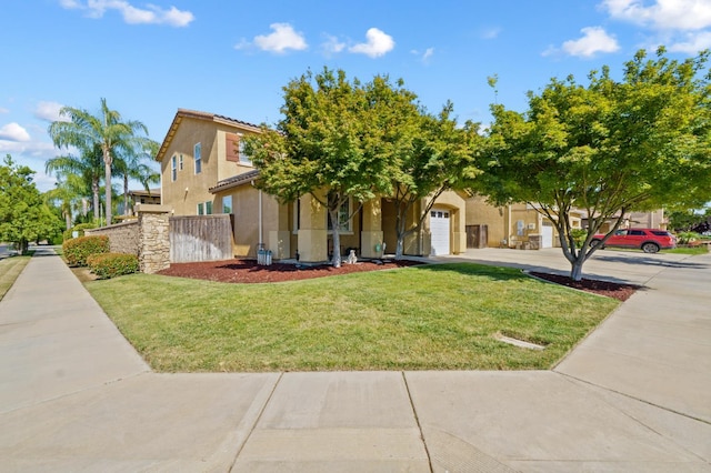 993 Pinewood Ave, Sanger, CA 93657 - view of front of property with stucco siding, a garage, concrete driveway, and a front lawn