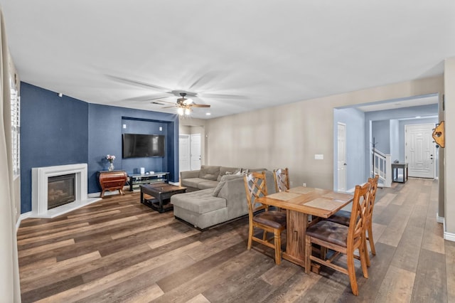 993 Pinewood Ave, Sanger, CA 93657 - dining space featuring wood finished floors, a glass covered fireplace, ceiling fan, and baseboards