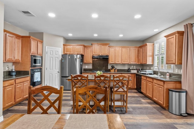 993 Pinewood Ave, Sanger, CA 93657 - kitchen with black appliances, under cabinet range hood, dark countertops, dark wood-style floors, and recessed lighting