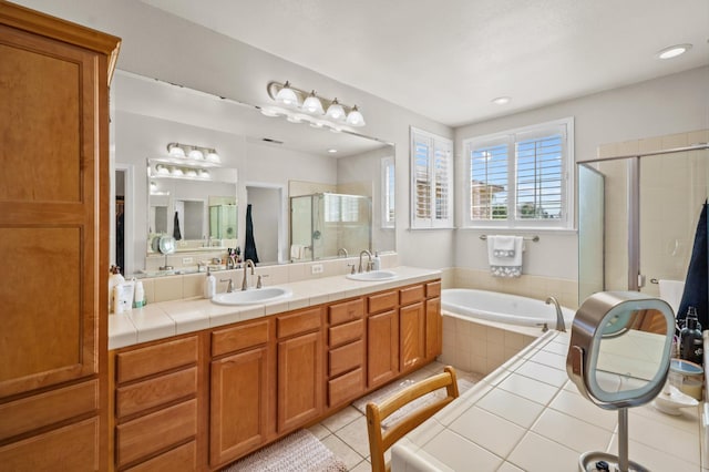 993 Pinewood Ave, Sanger, CA 93657 - bathroom with a shower stall, a garden tub, tile patterned floors, double vanity, and recessed lighting